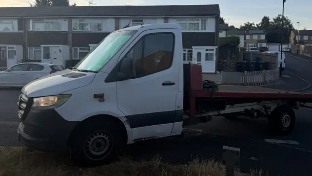 The full length of the empty flatbed bed, photographed from the side